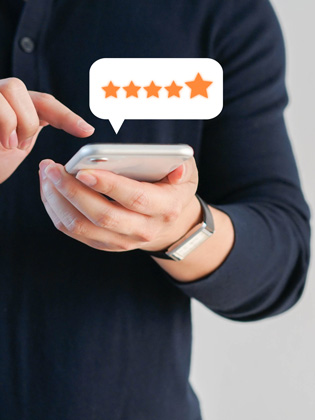 Person holding smart phone and leaving a 5 City Finance Bank Google review